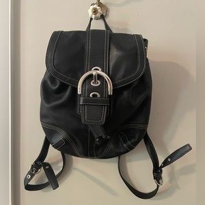 Black leather coach, mini backpack with silver hardware and adjustable straps.